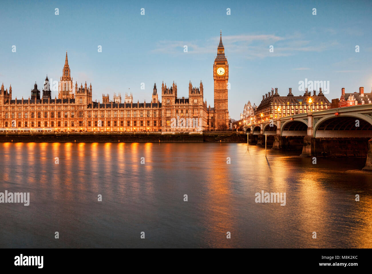 Big Ben, the Palace of Westminster and Westminster Bridge, reflecting in the River Thames. Stock Photo