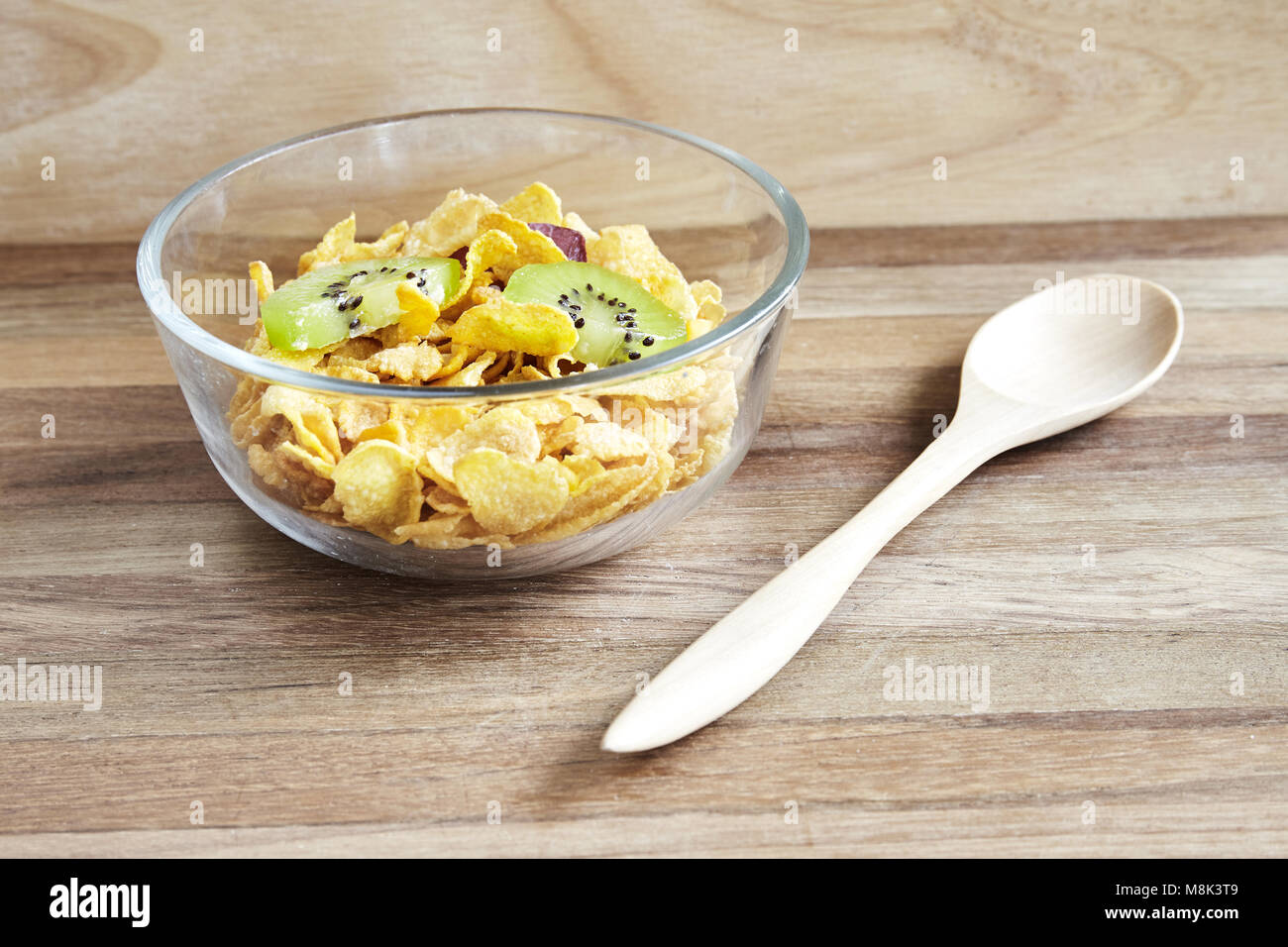 Glass bowl with cornflaked on wooden background with texture Stock Photo
