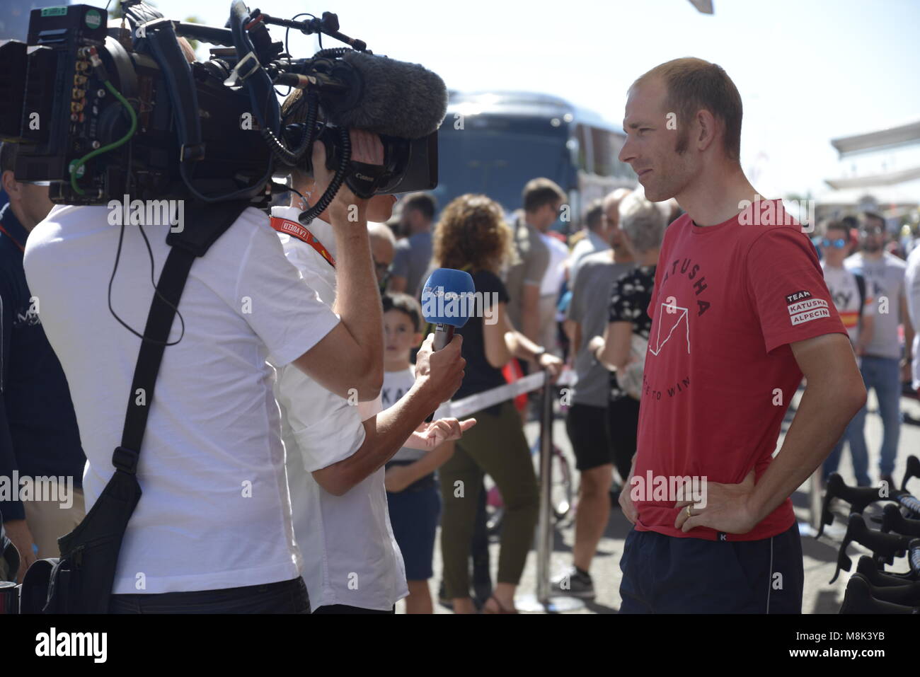 Sport journalist interviews danish cyclist Michael Morkov before stage departure in La Vuelta a España 2017, Madrid, Spain. Stock Photo