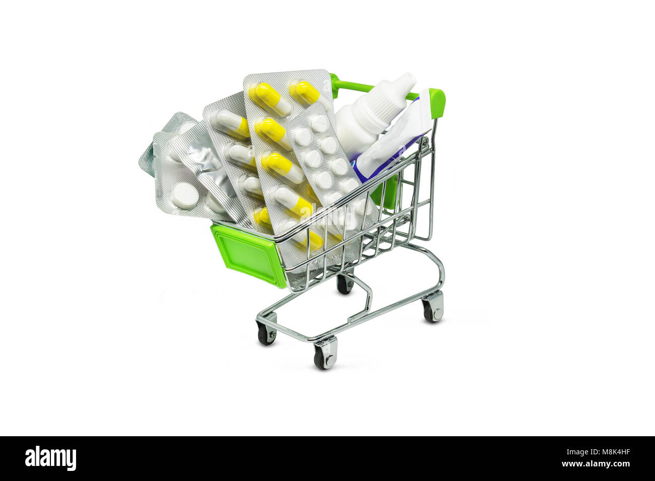 Closeup of a shopping cart full of pills isolated on white. buying medicines. Basket of tablets, ointments, sprays drops and other medicines Stock Photo