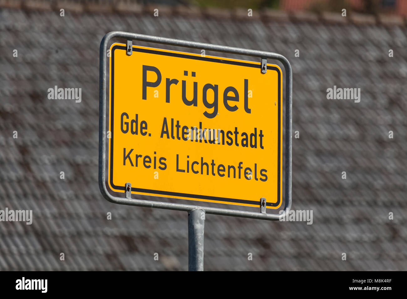 Town Sign of 'Prügel' in Franconia, Bavaria, Germany. Prügel being the German word for 'beating' or 'hitting' (s. o.) Stock Photo