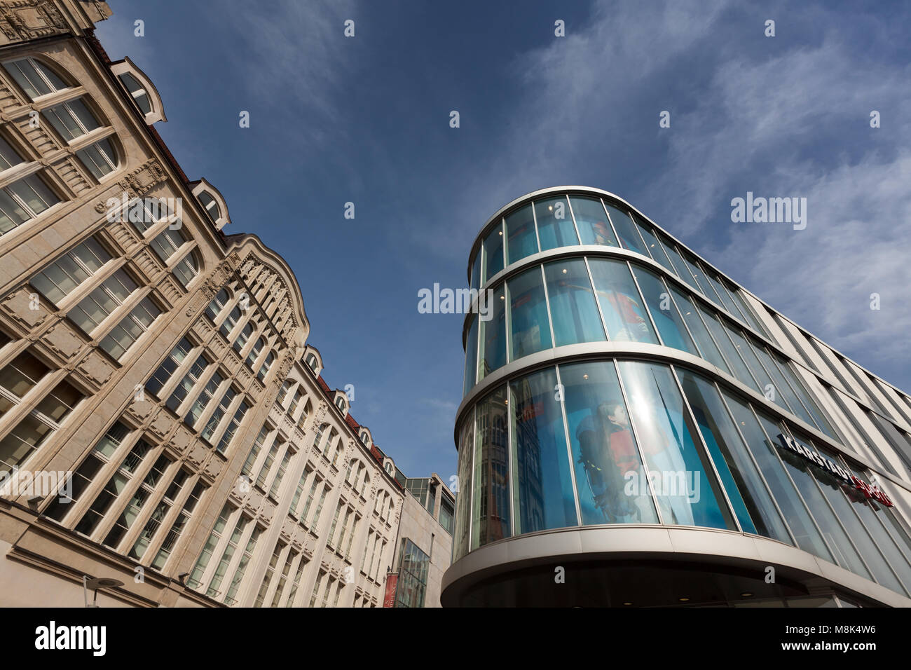 Old sandstone and modern glass facades side by side in downtown Erfurt, Germany Stock Photo