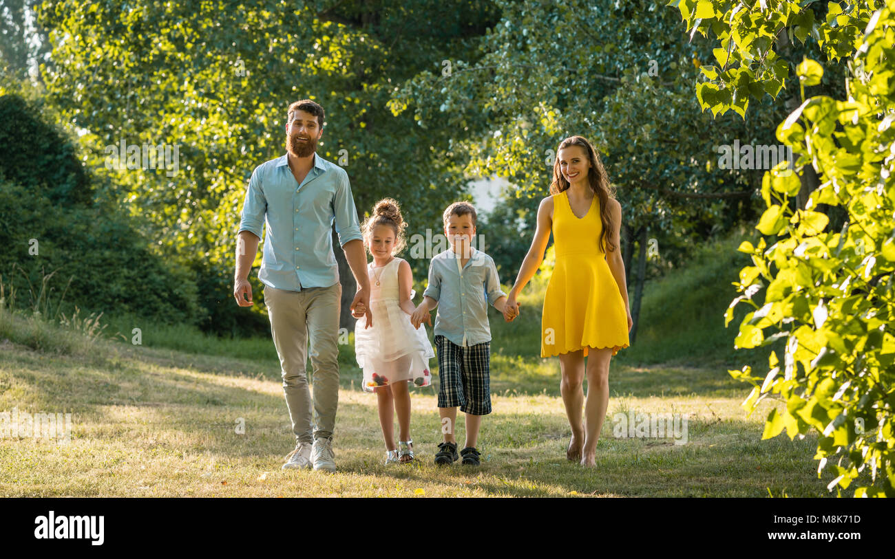 Photo inspiration: Fresh Look at Happy Family With Two Children Holding Hands During Recreational Walk