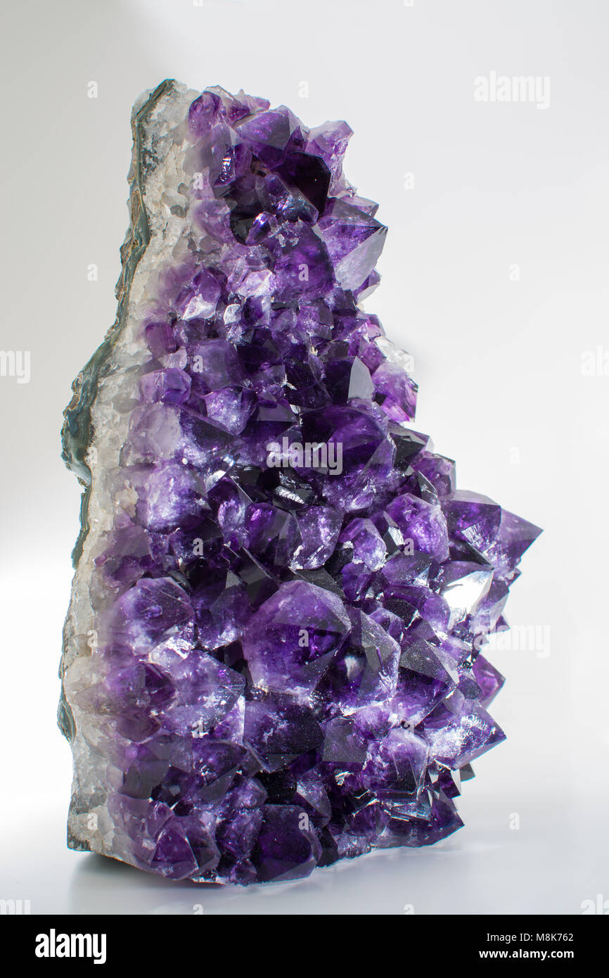 Beautiful big purple bright gemstone amethyst crystal isolated close up Stock Photo