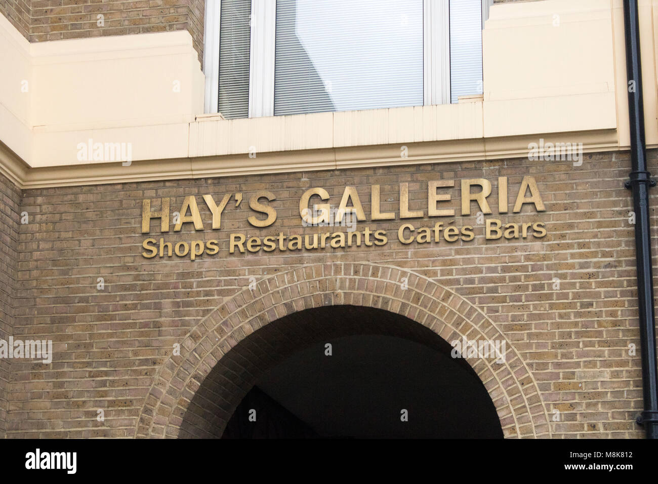 signs at hays galleria in london featuring shops, restaurants, cafe's and bars with stalls of gifts Stock Photo