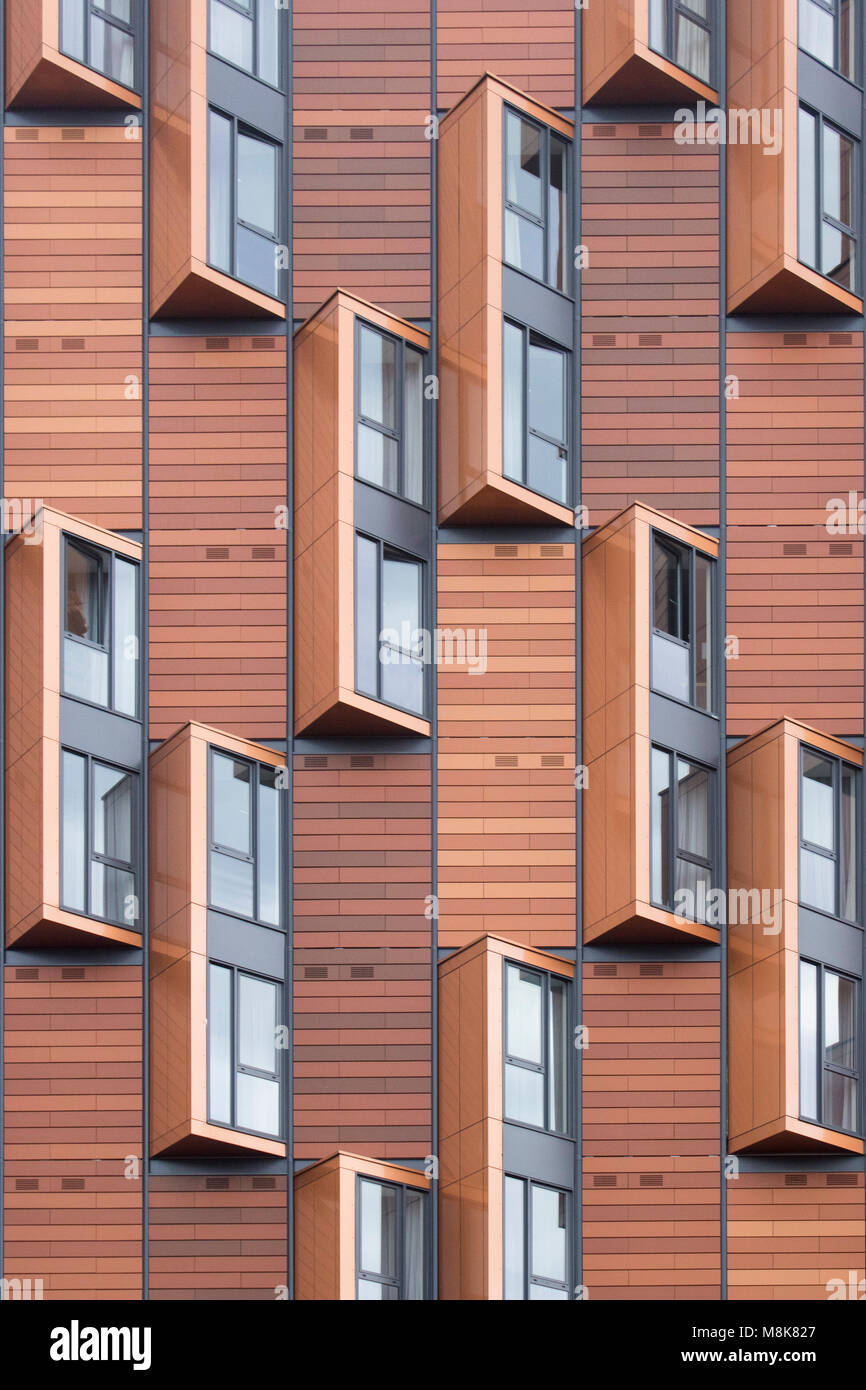modern brown wood apartment/flat building with creative art glass windows in london, near wembley stadium Stock Photo