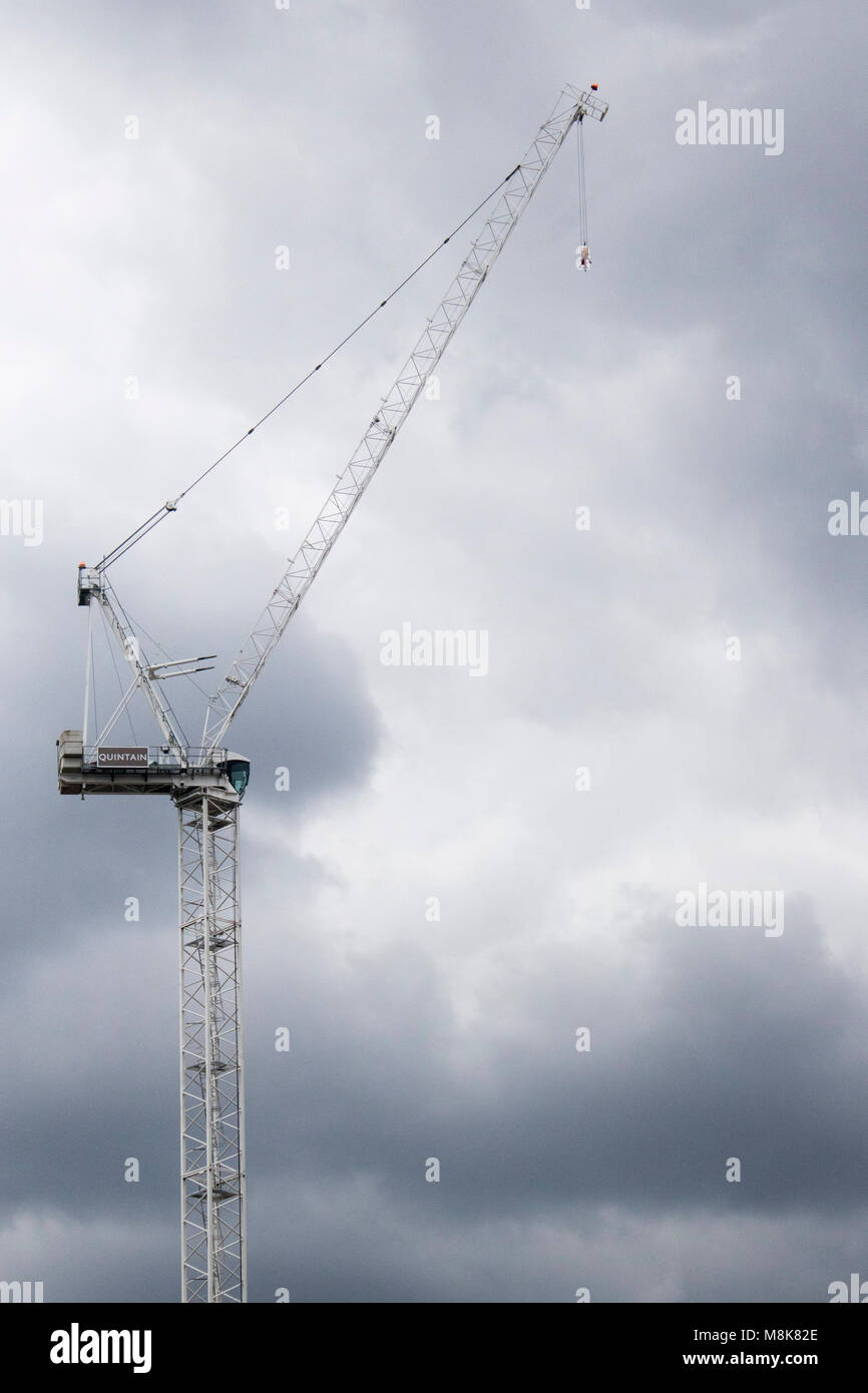 Mechanic crane for construction with grey cloudy sky in london, wembley near the stadium building Stock Photo