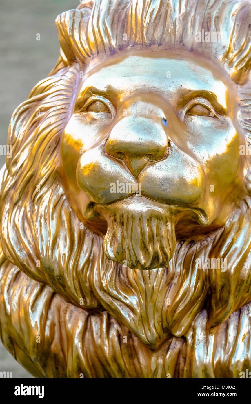 Smiling statue of lion painted with Gold Spray placed at Yas Gateway Park Abu Dhabi. Stock Photo