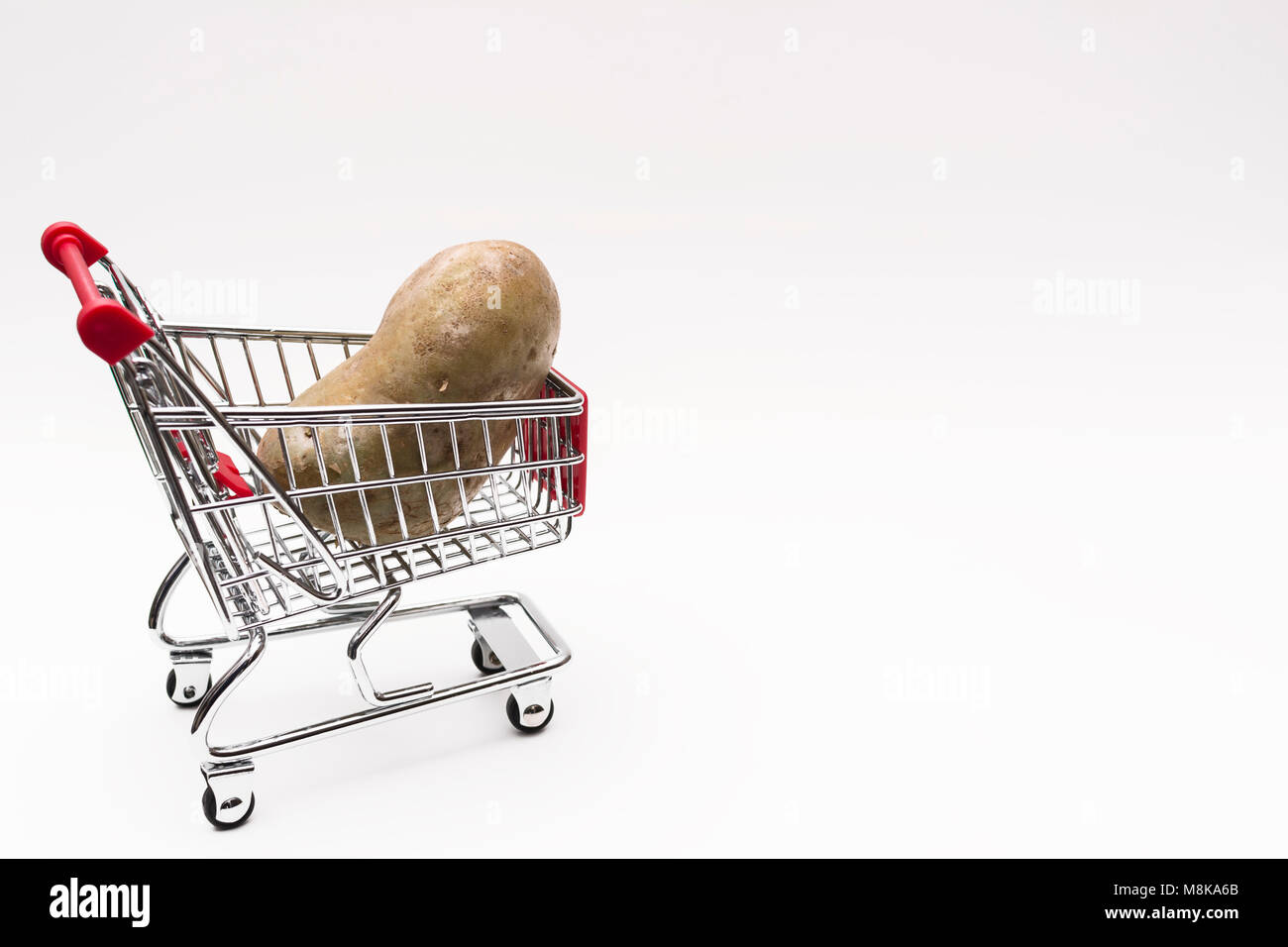 Buying a potatoes from supermarket, Potato in shopping cart, shoping cart isolated on white background Stock Photo