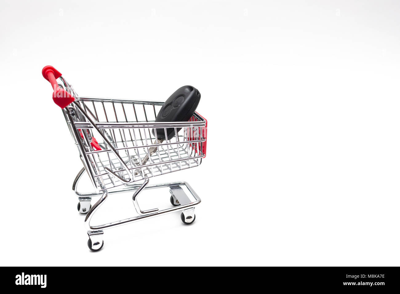 Buying a car from carshop, Car in shopping cart, shoping cart isolated on white background Stock Photo