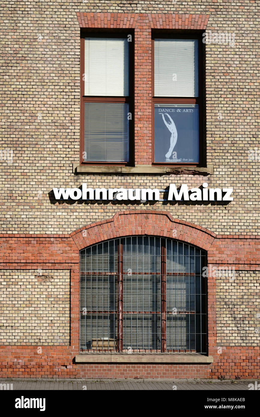 Mainz, Germany - February 24, 2018: The logo of the home furnishings market Wohnraum Mainz at the brick facade of an abandoned industrial building on  Stock Photo