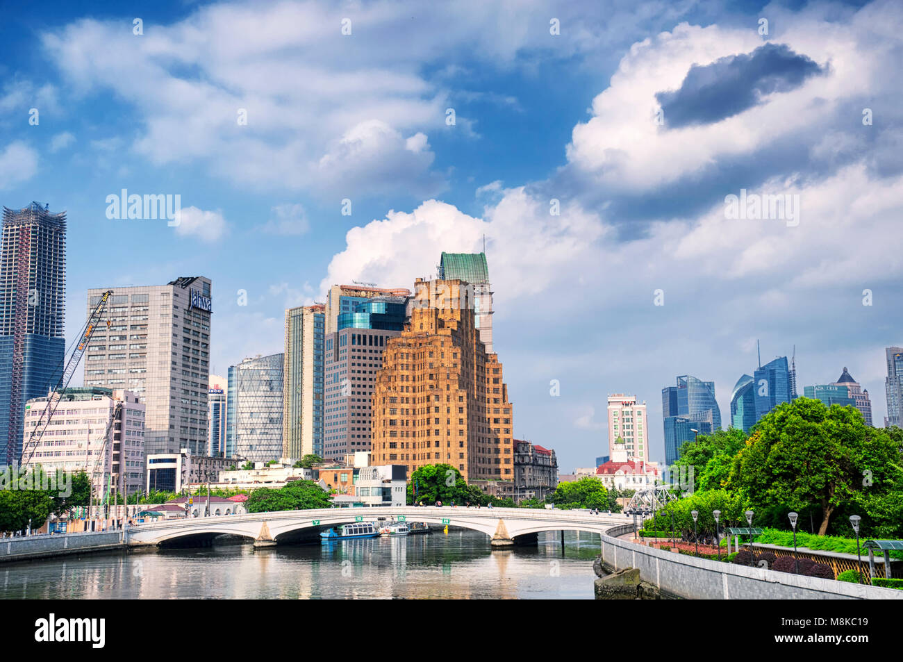 July 15, 2015. Shanghai, China. The Waibaidu (garden) and Huqiu Road bridges over the Wusong River (Suzhou Creek) with the modern buildings of Lujiaz Stock Photo