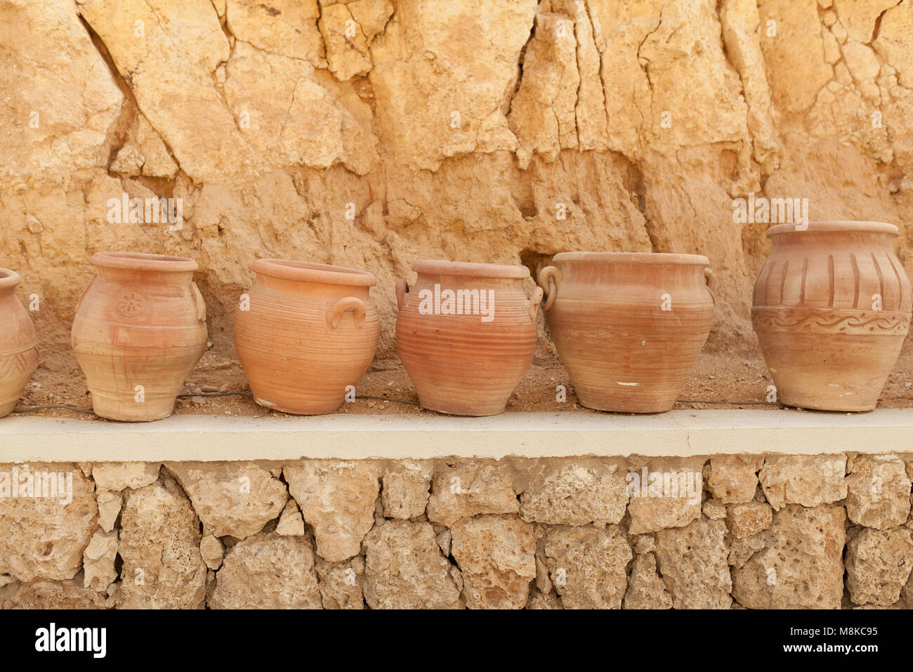 many large clay pots standing in a row outdoor Stock Photo