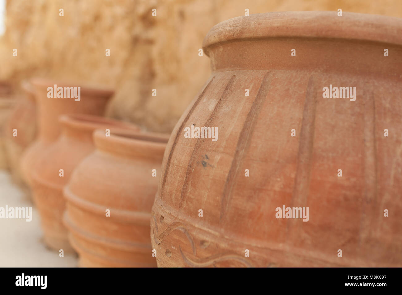 many large clay pots standing in a row outdoor Stock Photo