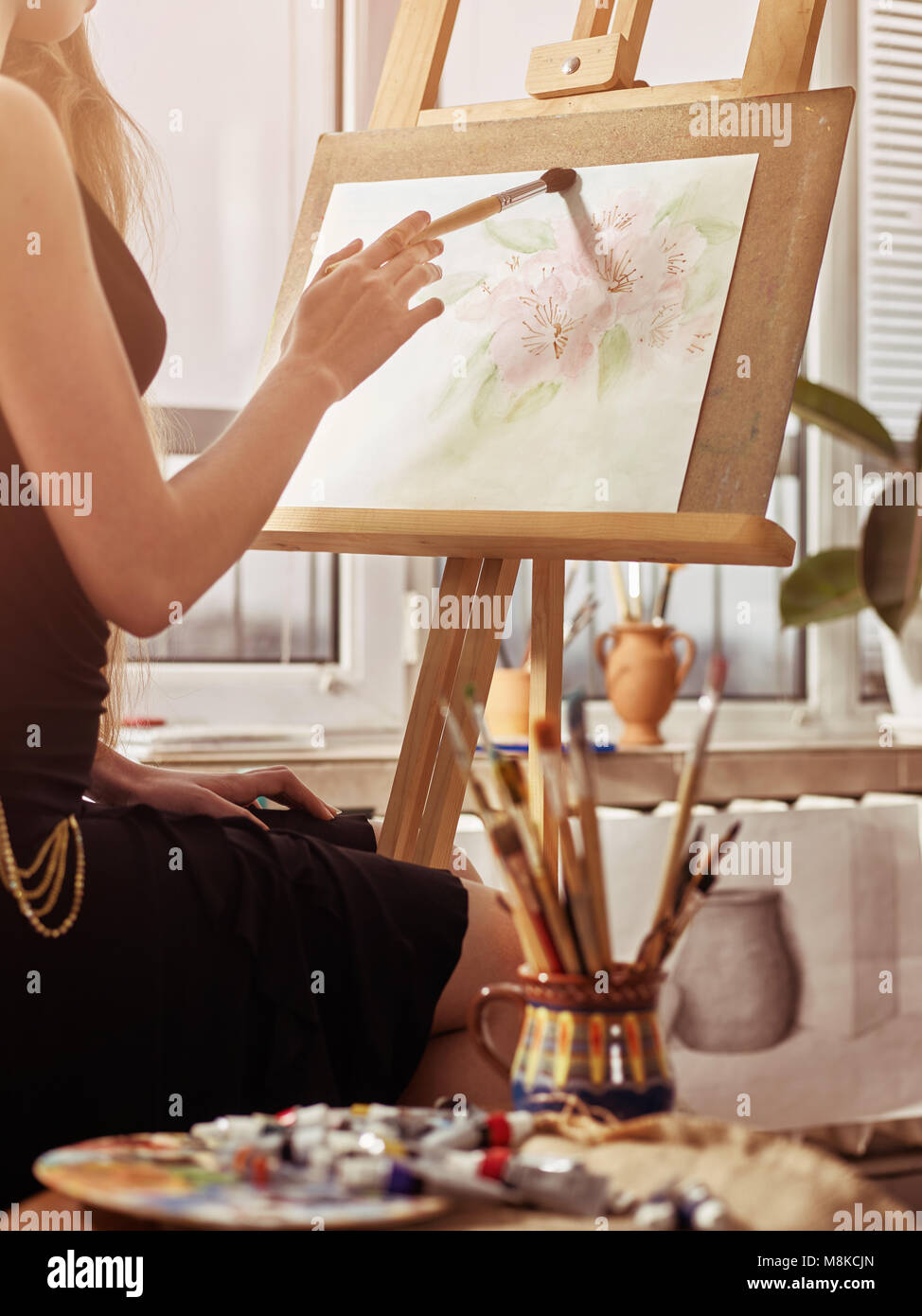 Artist Painting On Easel In Studio Girl Paints With Brush Stock Photo 