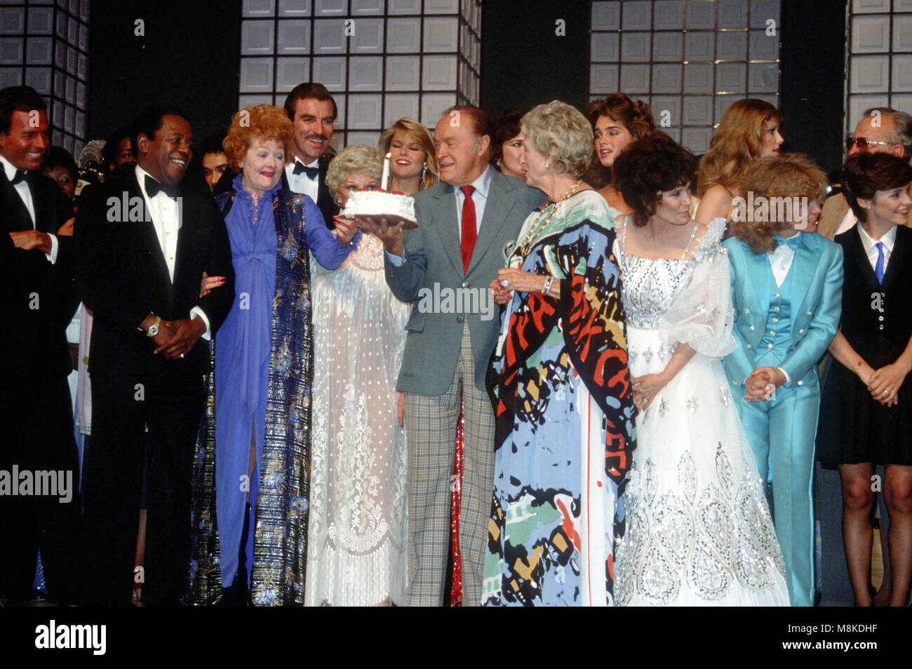 Washington DC., USA, May 20, 1983 Hollywood star Bob Hope is presented with a cake by Lucille Ball on the occasion for his 80th birthday. This was a special being filmed by NBC at the Kennedy Center for the Performing Arts in DC. Guests included President Ronald Reagan,Nancy Reagan,  Dolores Hope, Governor Ray Schafer, Brooke Shields, George Burns, Kathryn Crosby, Tom Selleck, Lynda Carter, Julio Iglesias, Christie Brinkley, Howard Cosell, Babara Mandrell, Loretta Lynn, Dudley Moore, Phyllis Diller, George C. Scott, Cheryl Tiegs, Tommy Tune, Tiggy, Flip Wilson, Sheena Easton, Ann Jillian, Robe Stock Photo