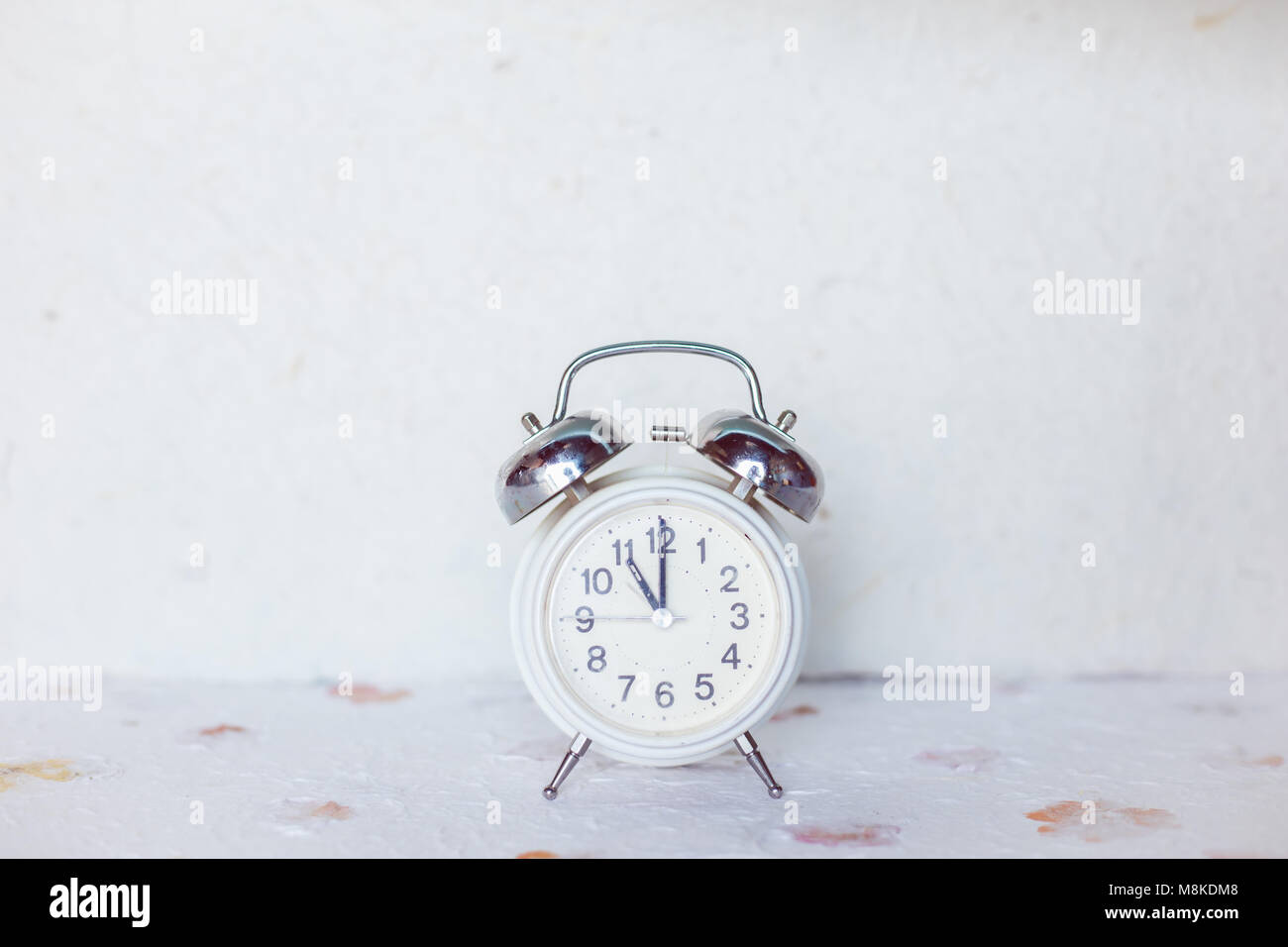 Vintage alarm clock on white background Stock Photo - Alamy