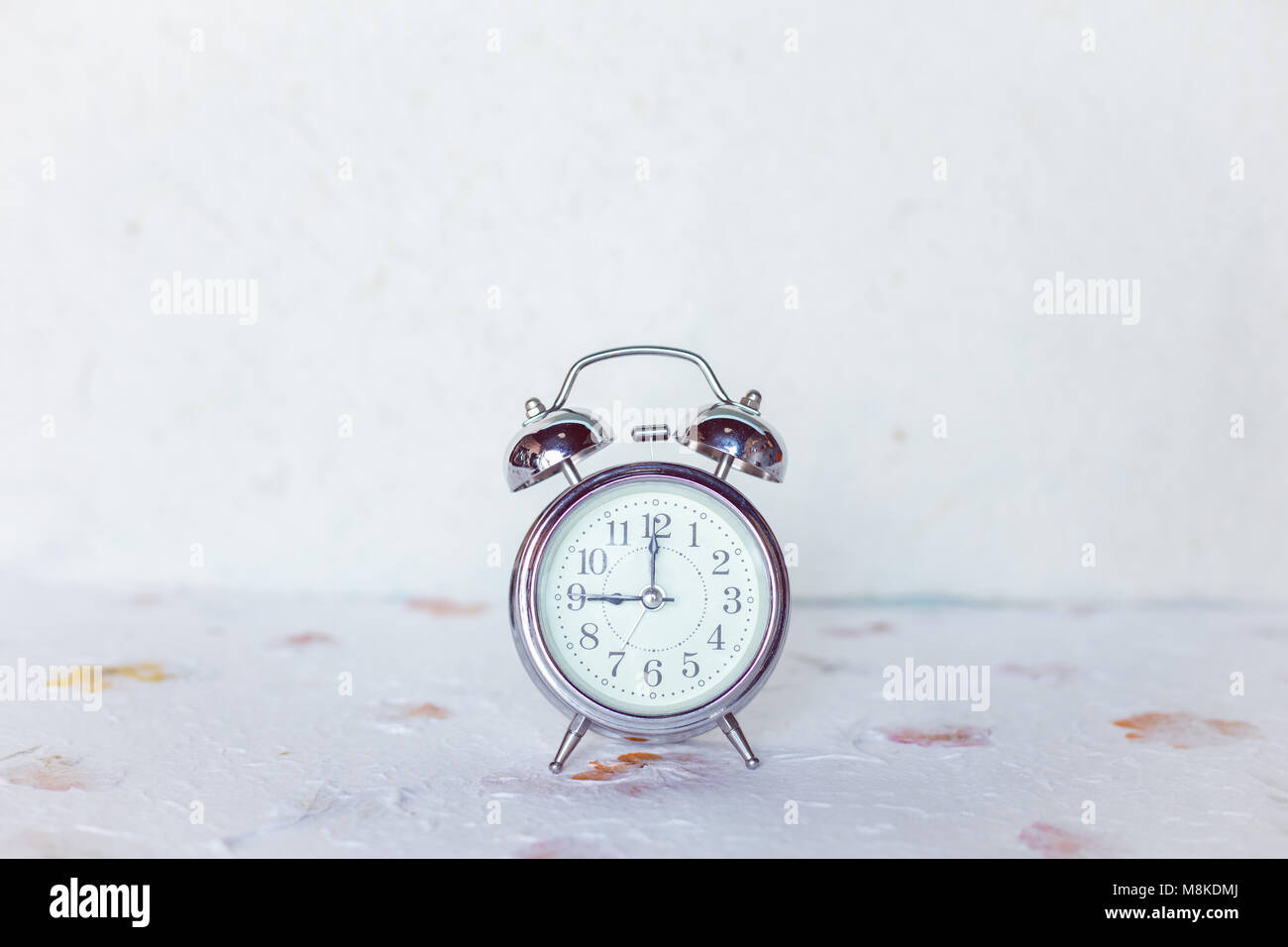 Vintage alarm clock on white background Stock Photo - Alamy