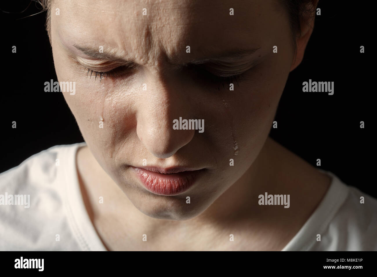 sad woman crying on black background, closeup portrait Stock Photo - Alamy
