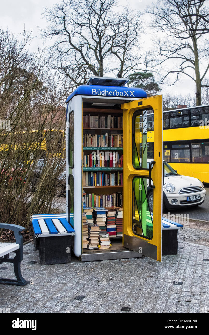 Berlin-Grunewald.Telephone kiosk,BücherboXX,book box. A small ‘honesty library’ with books.A shelf has books relating to the Gleis 17 memorial. Stock Photo