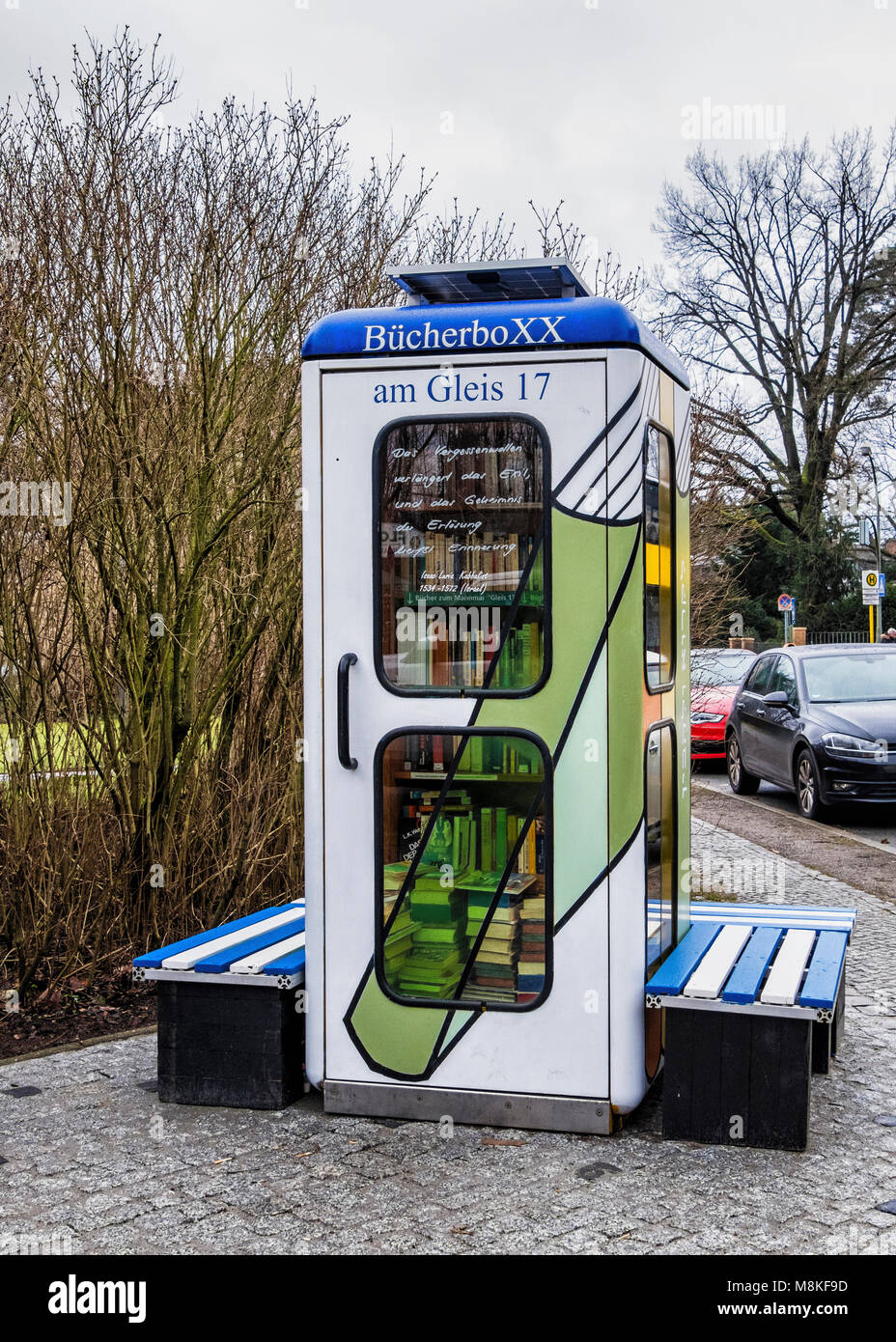 Berlin-Grunewald.Telephone kiosk,BücherboXX,book box. A small ‘honesty library’ with books.A shelf has books relating to the Gleis 17 memorial. Stock Photo