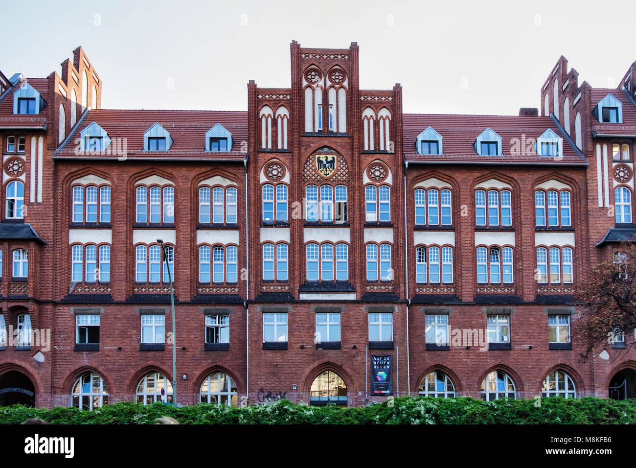 Berlin Kreuzberg. Old Post Office building exterior with clinker brick façade, gables, arched windows & decorative details Historic listed building in Stock Photo