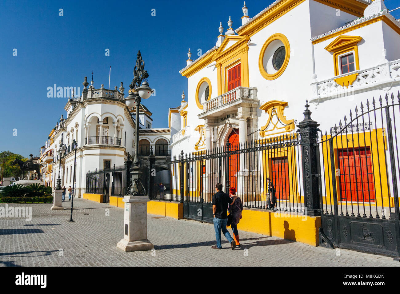 Seville, Andalusia, Spain : Tourists walk past the Maestranza bullring ...