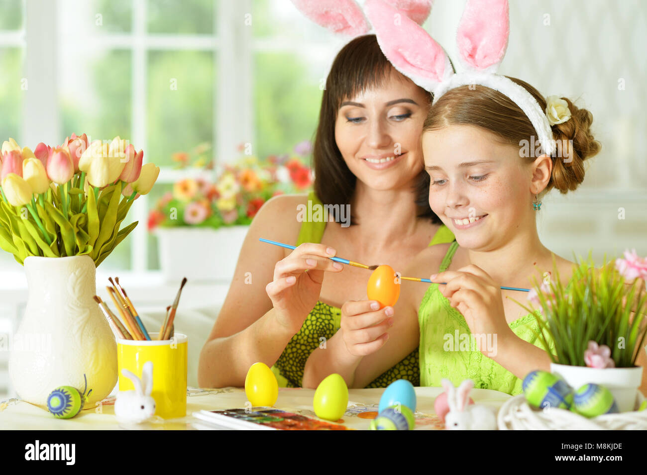 Mother and daughter colouring eggs Stock Photo
