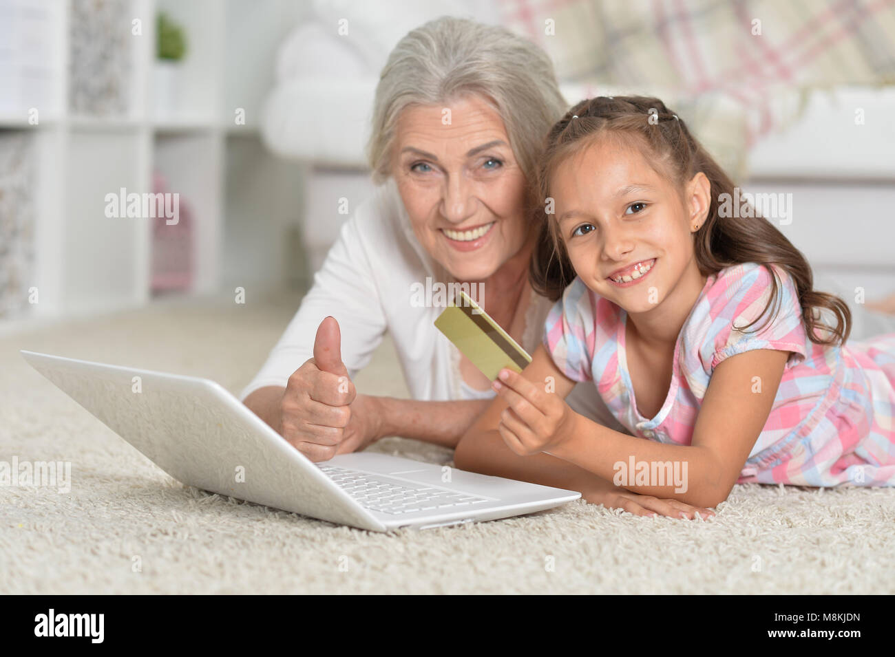 grandmother and granddaughter using laptop Stock Photo - Alamy