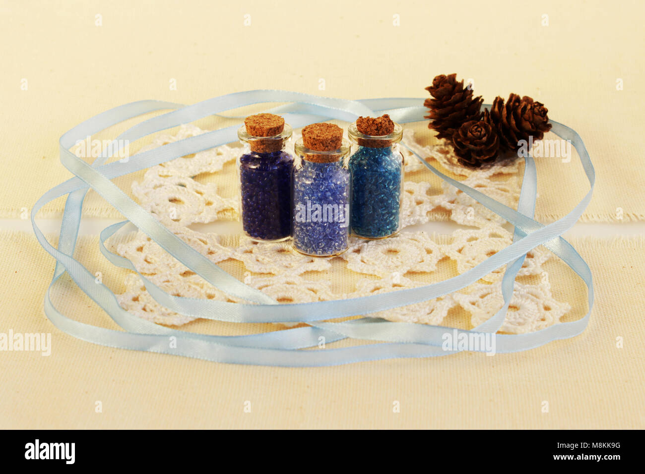 Three Tiny Glass Bottles With A Cork Stopper Filled With A Blue