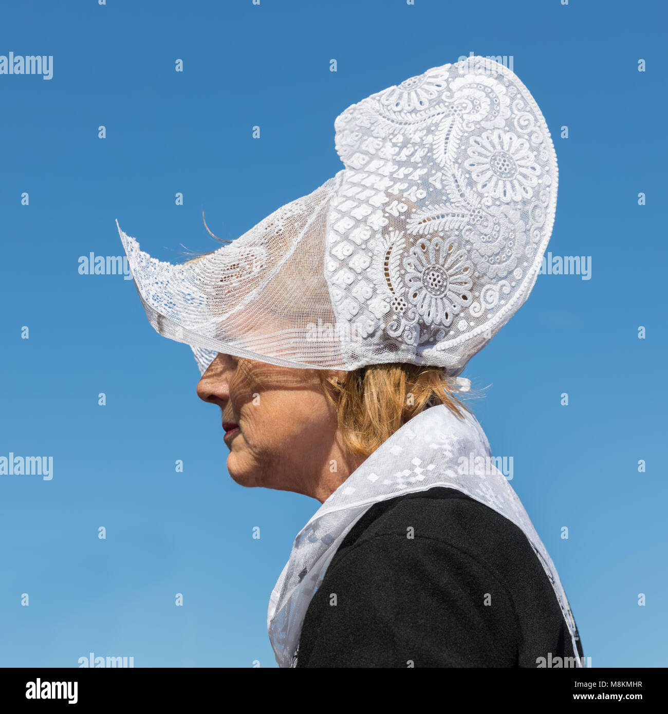 Dutch woman with traditional clothing and headgear at local fair Stock Photo