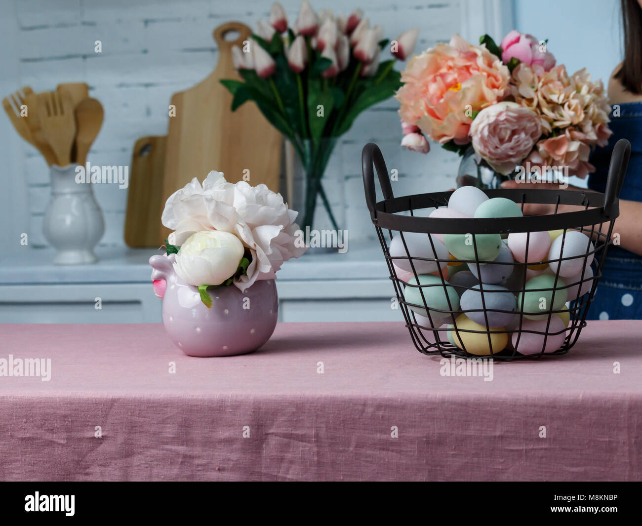 Easter basket with colored eggs and flowers on pink table Stock Photo ...