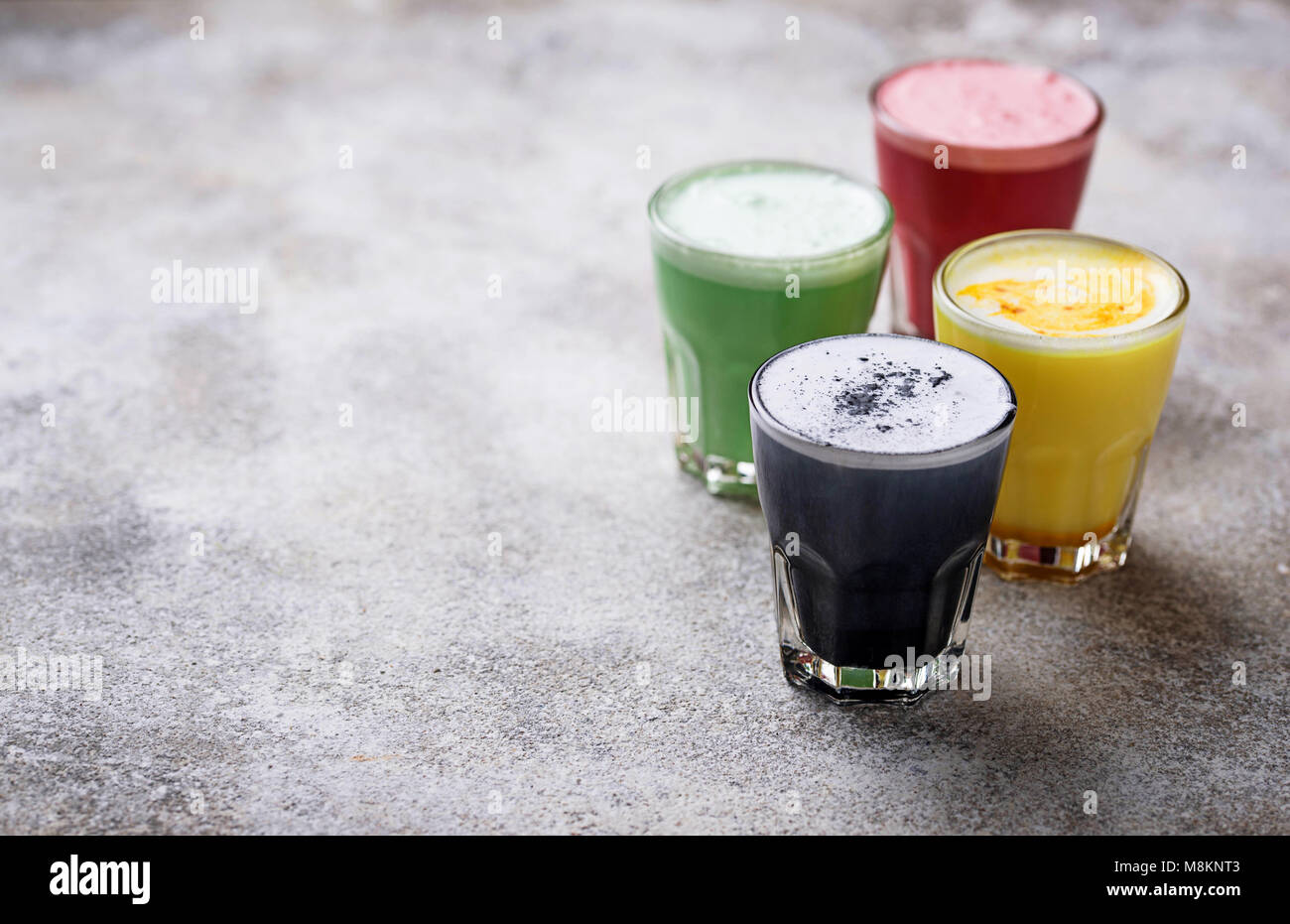 Colorful super lattes with charcoal, beetroots, matcha tea and turmeric