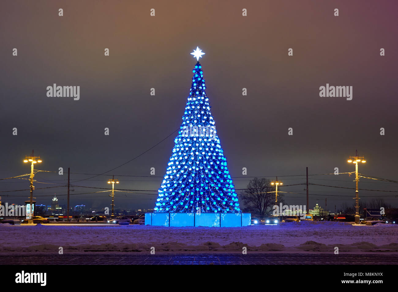 Christmas tree with lights in the foreground and artificial Northern