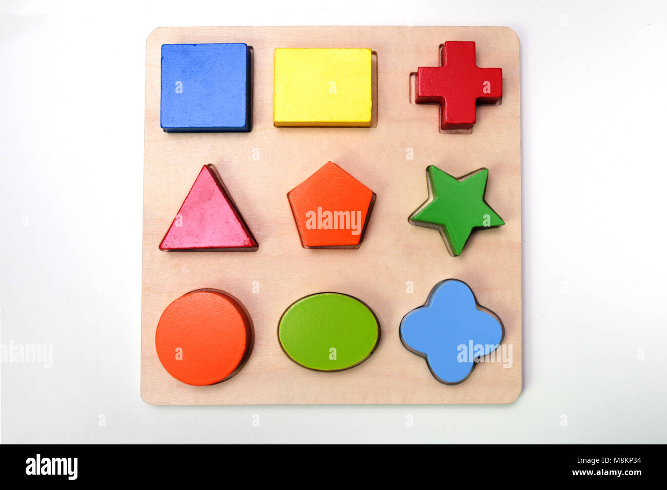 Puzzle with colored wooden figures Stock Photo - Alamy