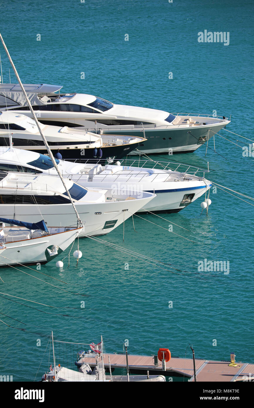 Monte-Carlo, Monaco - March 17, 2018: Luxurious Yachts And Megayachts Lined Up In The Monte-Carlo Harbour (Port Hercule), French Riviera Stock Photo
