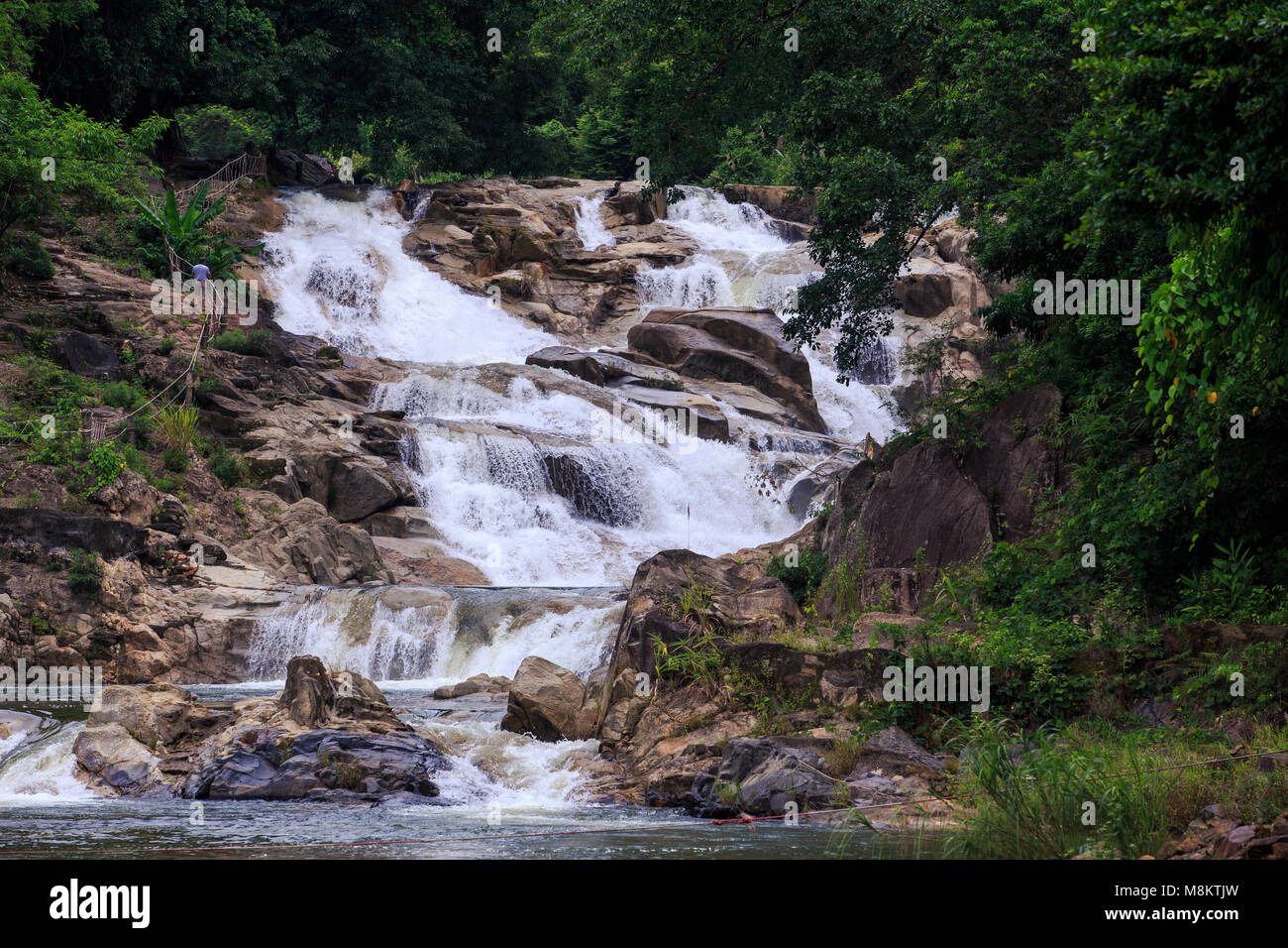 cascade of small shallow foamy mountain river waterfalls in brown ...
