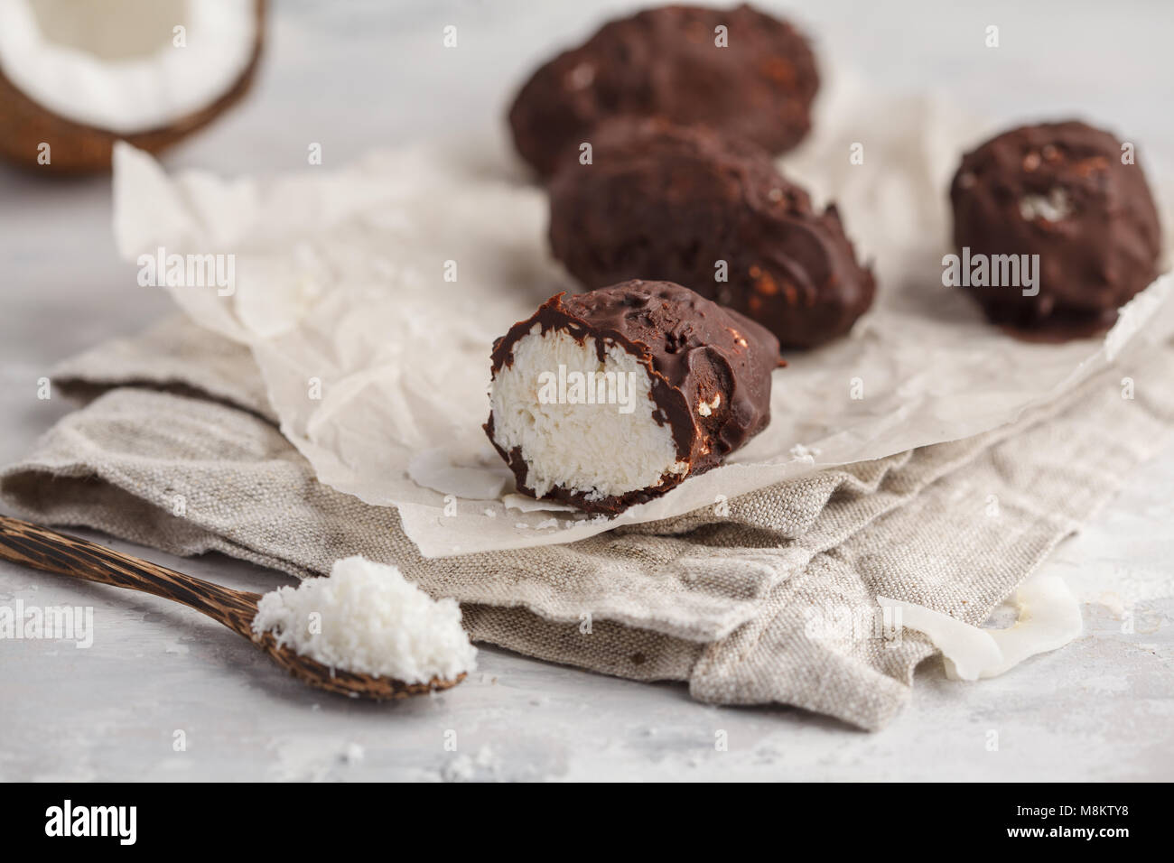 Raw homemade vegan chocolate coconut dessert bounty. Healthy vegan food concept. Stock Photo