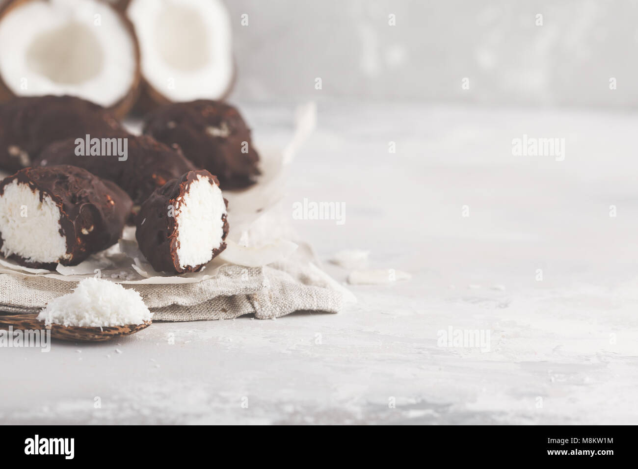 Raw homemade vegan chocolate coconut dessert bounty. Healthy vegan food concept. Stock Photo