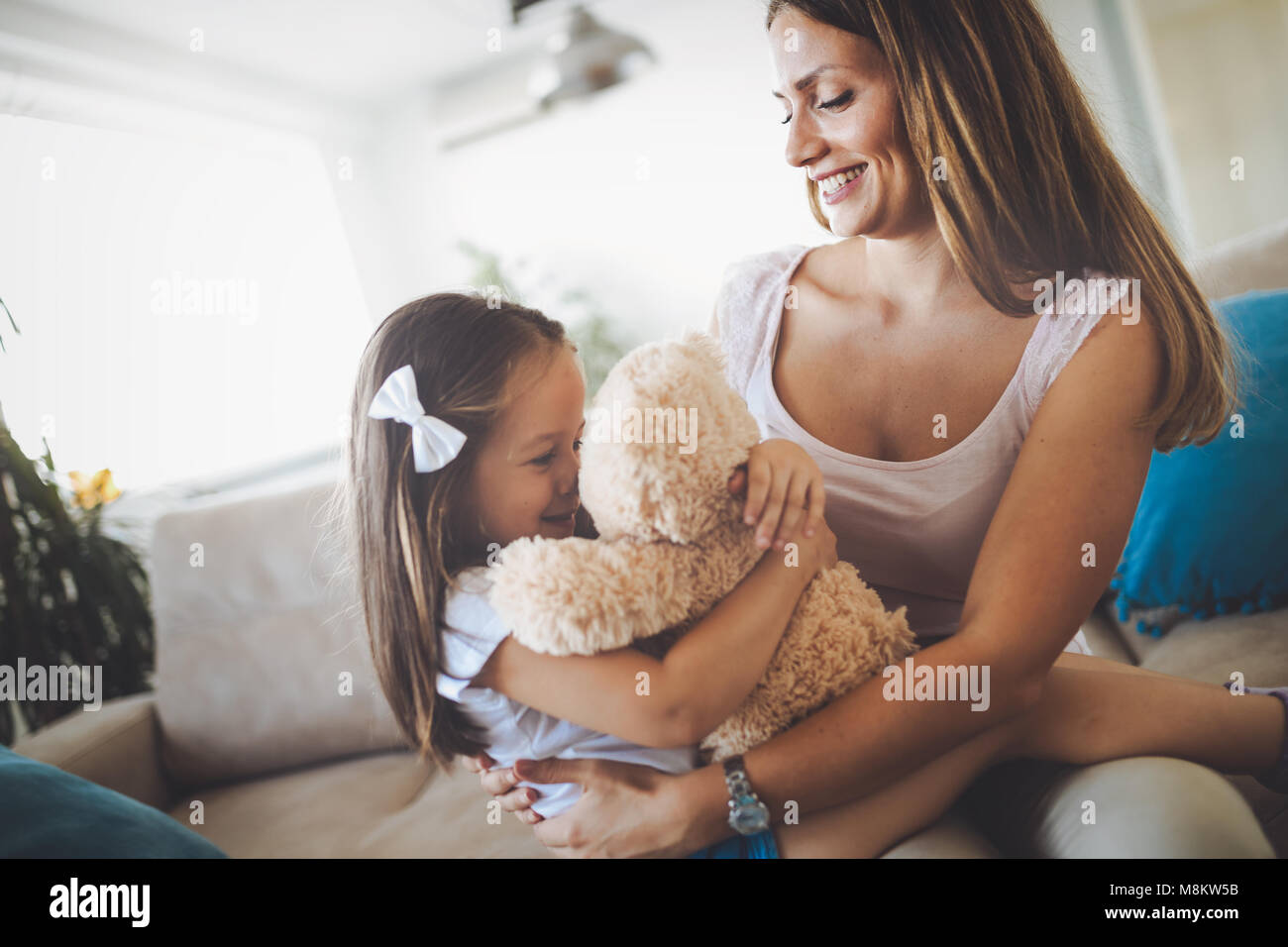 Mother and daughter portrait with teddy bear Stock Photo - Alamy