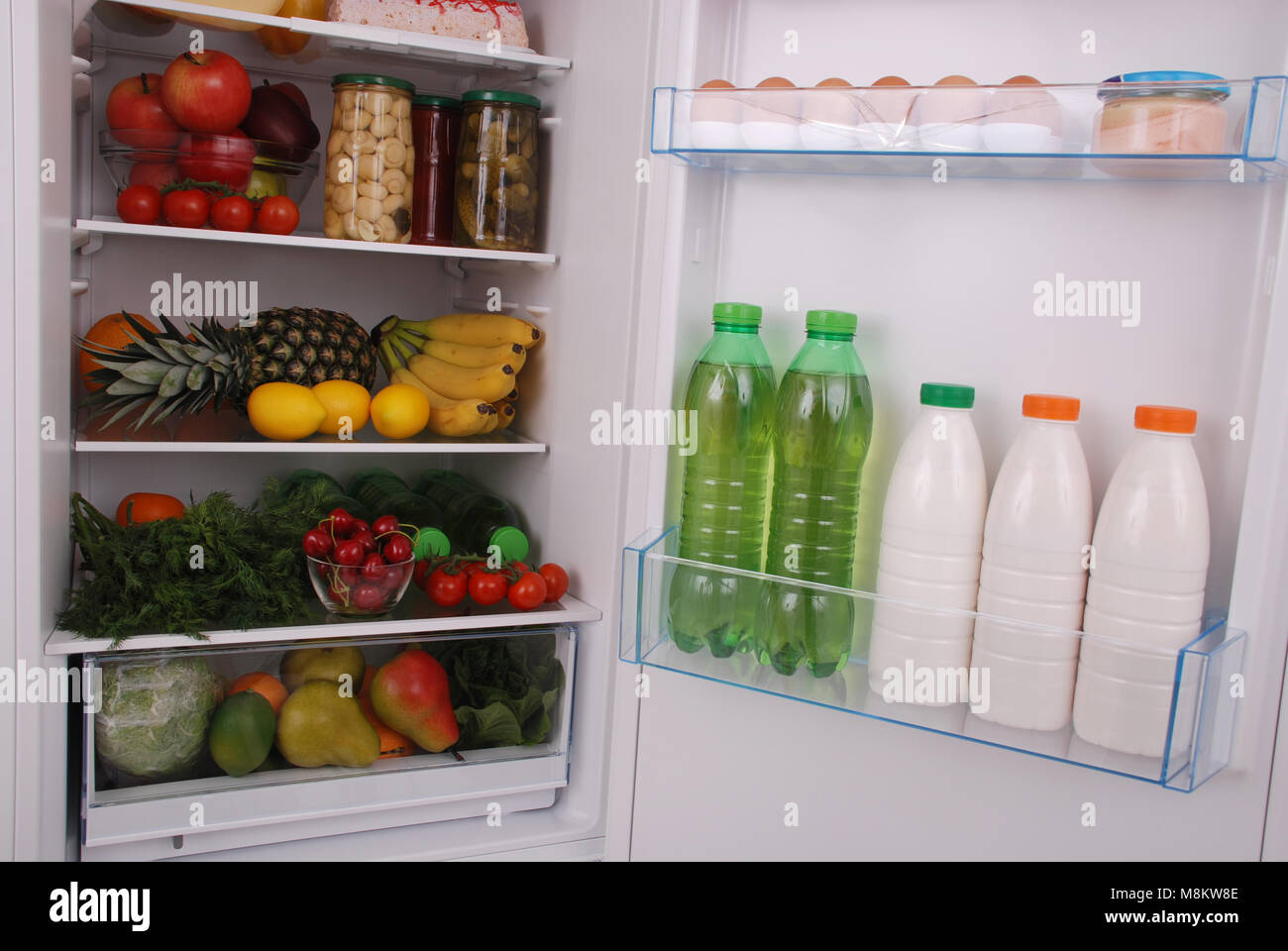 Open refrigerator full with some kinds of food and drinks Stock Photo