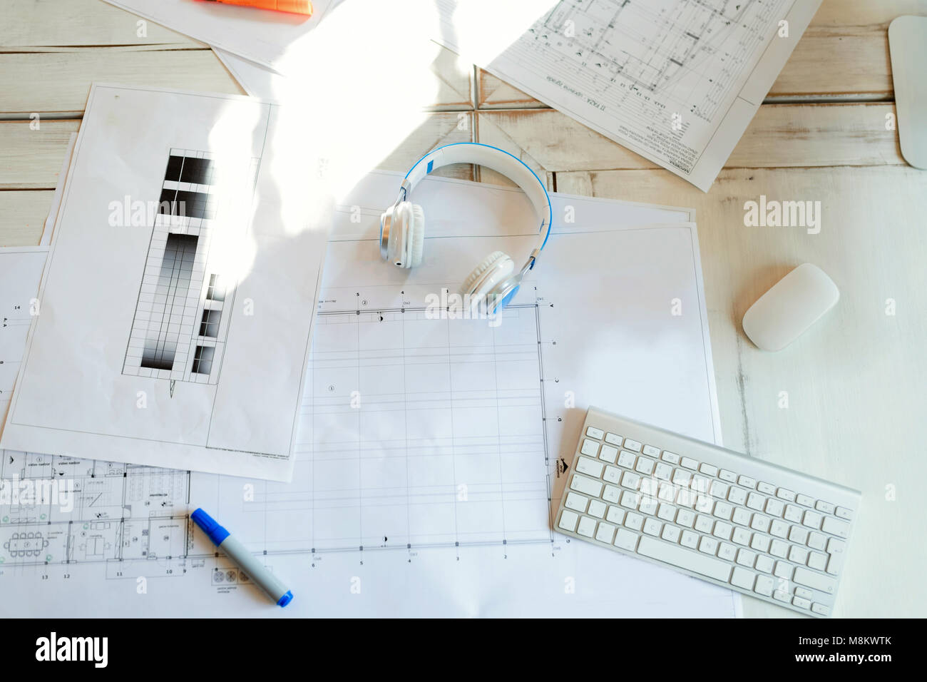 Architectural project, blueprints, blueprint rolls on wooden desk table Stock Photo