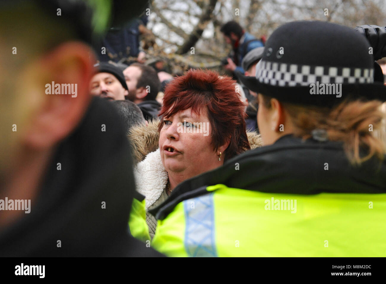 London, UK. 18th March, 2018. A female nationalist demonstrator behind police lines at Speakers Corner prior to the arrival of Tommy Robinson (political activist and co-founder, former spokesman and leader of the English Defence League - EDL), Hyde Park, London, United Kingdom.    The corner was very densely packed with several hundred people which meant that it was virtually impossible for the vast majority of people to actually see him or hear what he was saying. Credit: Michael Preston/Alamy Live News Stock Photo