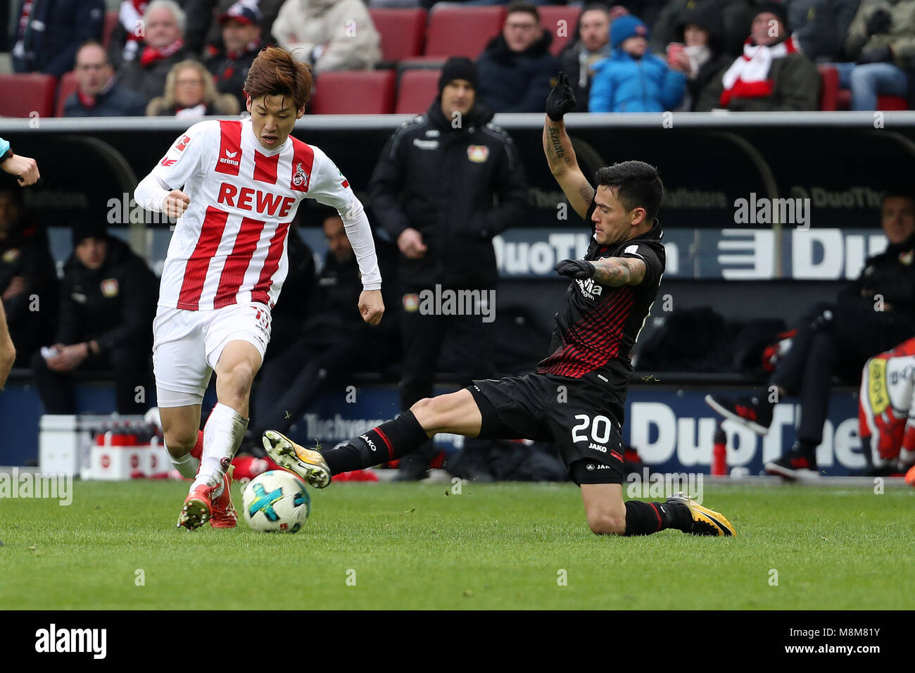 Cologne, Germany. 18th Mar, 2018. Charles Aranguiz (R) of Leverkusen vies with Yuya Osako of Cologne during the Bundesliga soccer match between Cologne and Leverkusen in Cologne, Germany, March 18, 2018. Cologne won 2-0. Credit: Ulrich Hufnagel/Xinhua/Alamy Live News Stock Photo