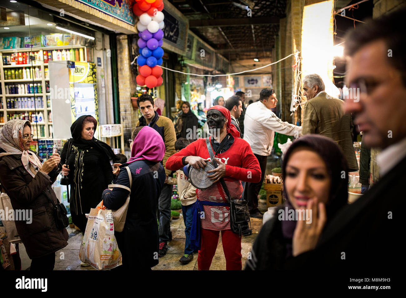 Tehran. 18th Mar, 2018. A man (C) dressed as a Haji Firouz, a ...