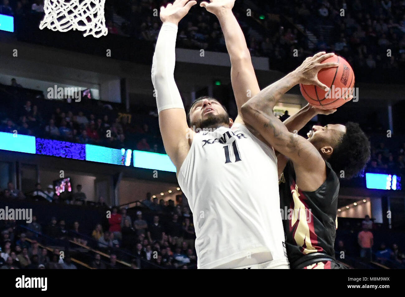 Nashville, Tennessee, USA. 18th Mar, 2018. Florida State Seminoles guard Braian Angola (11) tries to shoot over Xavier Musketeers forward Kerem Kanter (11) at Bridgestone Arena on March 18, 2018 in Nashville, Tennessee. Credit: FGS Sports/Alamy Live News Stock Photo