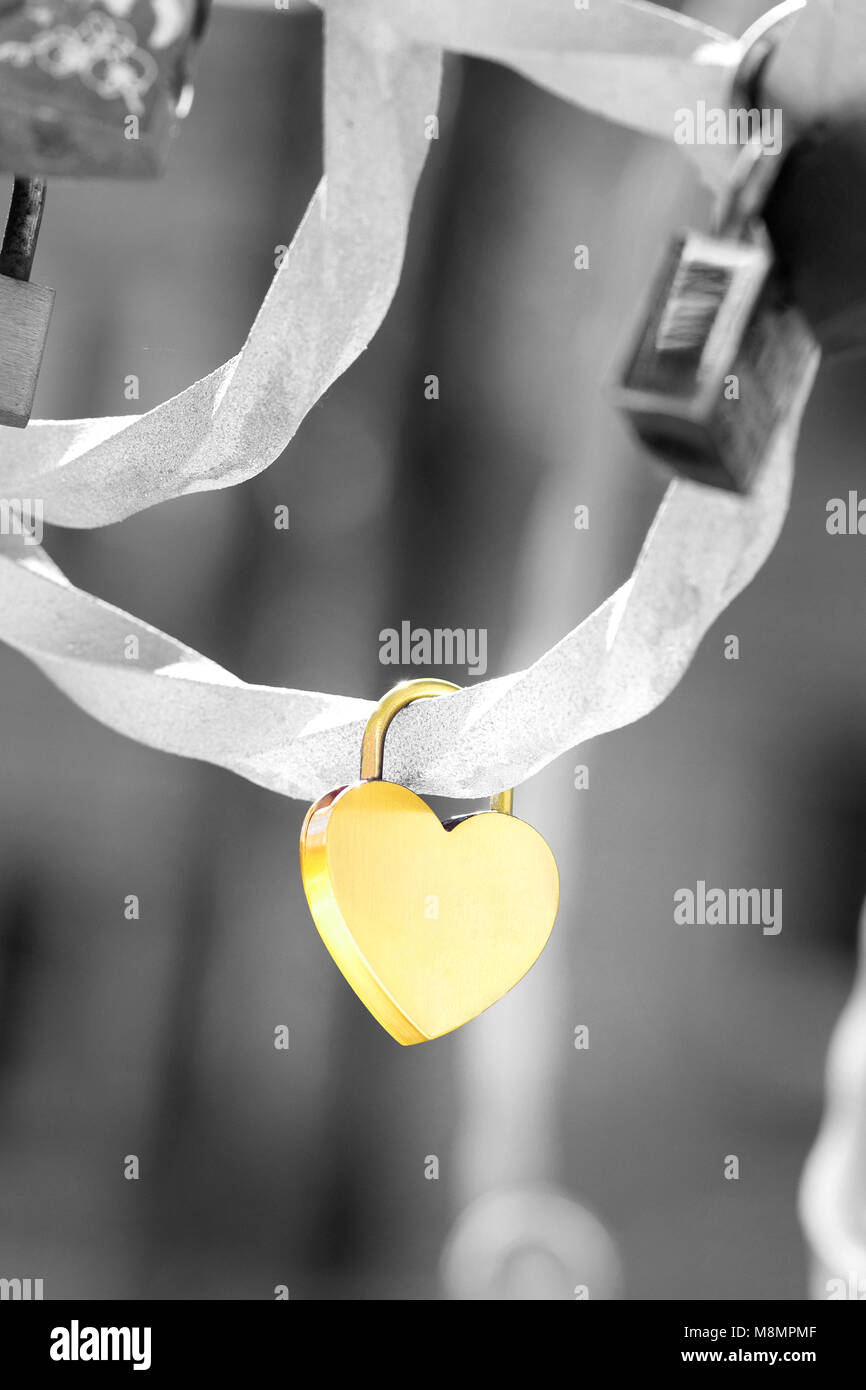 A metallic heart shaped love padlock isolated on black and white background. Clipping path available Stock Photo