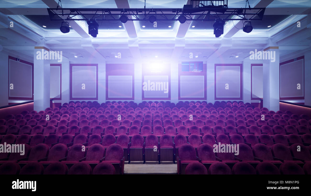 Concert hall of the cinema with red new chairs. The interior of the hall in  cinema view from the stage Stock Photo