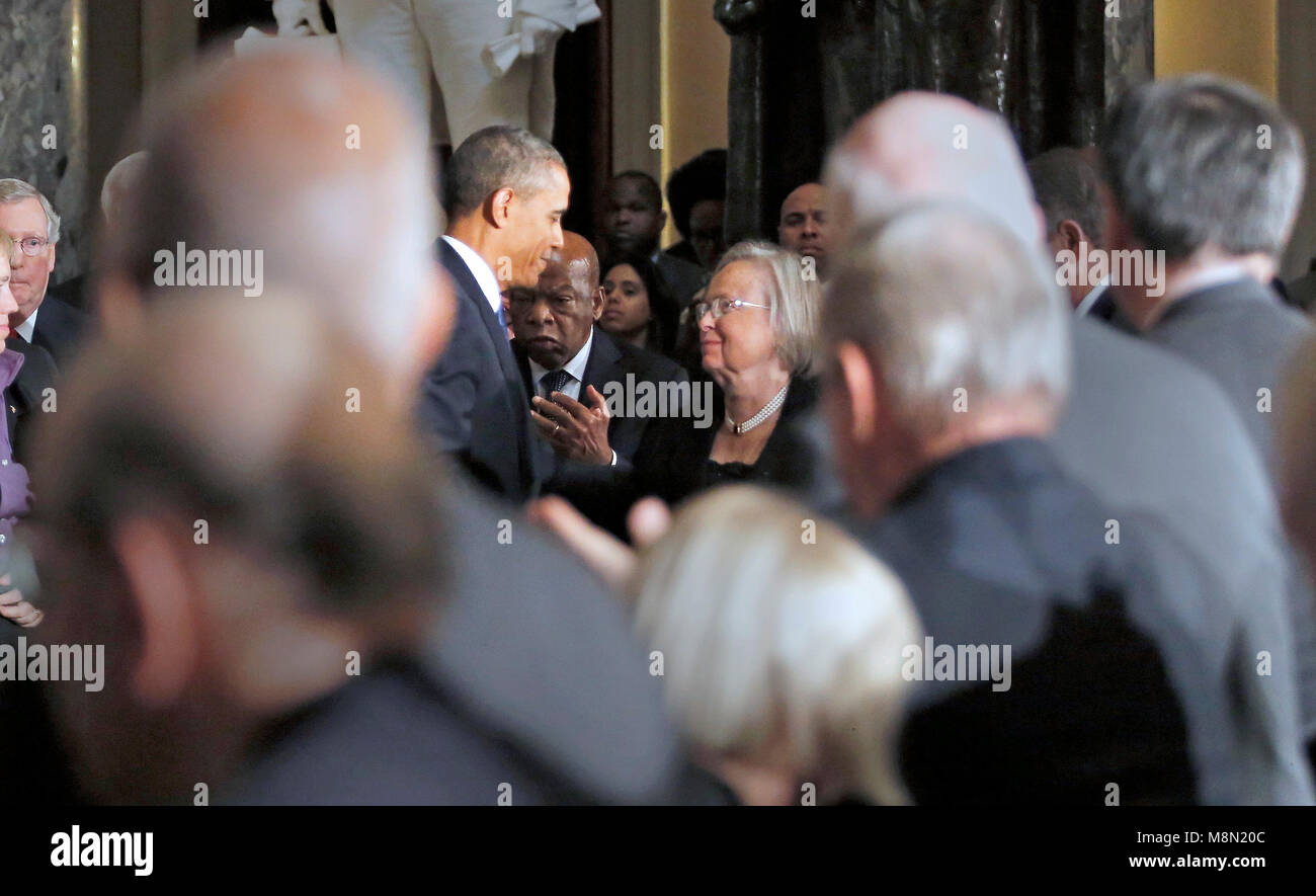 United States President Barack Obama, left, speaks to Tom Foley's wife Heather, right, during a memorial service honoring former Speaker of the U.S. House Thomas S. Foley (Democrat of Washington) in the U.S. Capitol in Washington, D.C. on October 29, 2013.   Foley represented Washington's 5th Congressional District was the 57th Speaker of the US House of Representatives from 1989 to 1995. He later served as US Ambassador to Japan from 1997 to 2001. U.S. Representative John Lewis (Democrat of Georgia) is seen between the President and Mrs. Foley. Credit: Aude Guerrucci / Pool via CNP /MediaPunc Stock Photo
