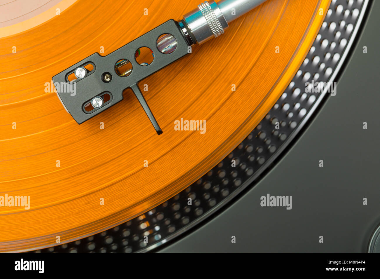 turntable pickup arm closeup top view on orange colored vinyl record Stock  Photo - Alamy